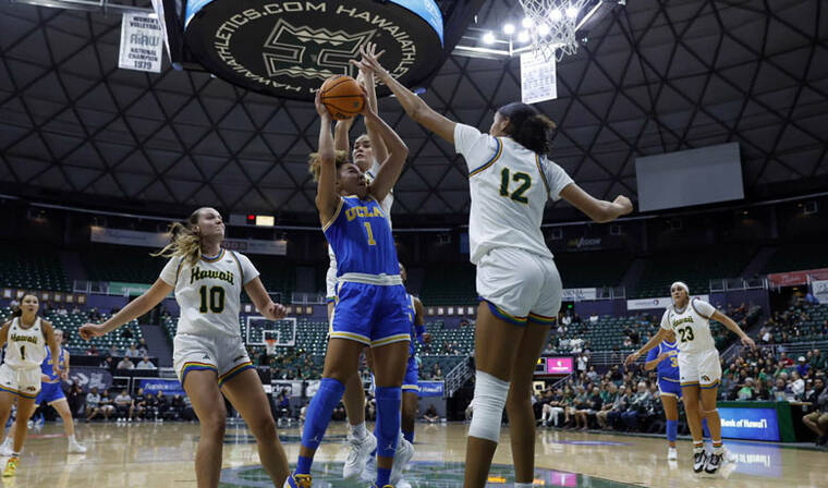 JAMM AQUINO / JAQUINO@STARADVERTISER.COM
                                Hawaii forward Imani Perez (12) blocks a shot by UCLA guard Kiki Rice (1) during the first half of a women’s NCAA basketball game.