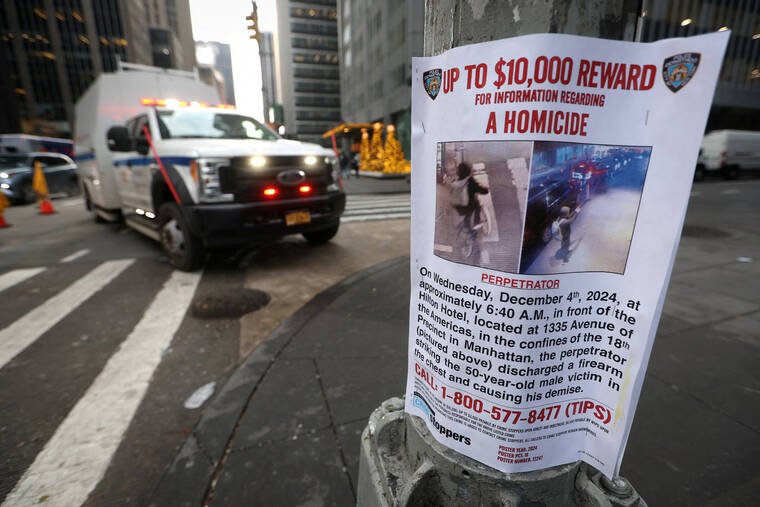 REUTERS/MIKE SEGAR
                                A poster is attached to a lamp post outside the Hilton hotel near the scene where the CEO of UnitedHealthcare Brian Thompson was shot dead in Midtown Manhattan, in New York City.