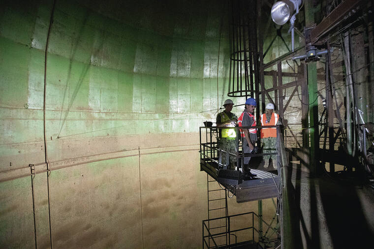 GEORGE F. LEE / 2023
                                Visitors tour a fuel tank at the Red Hill Fuel Storage Facility in Halawa Valley.