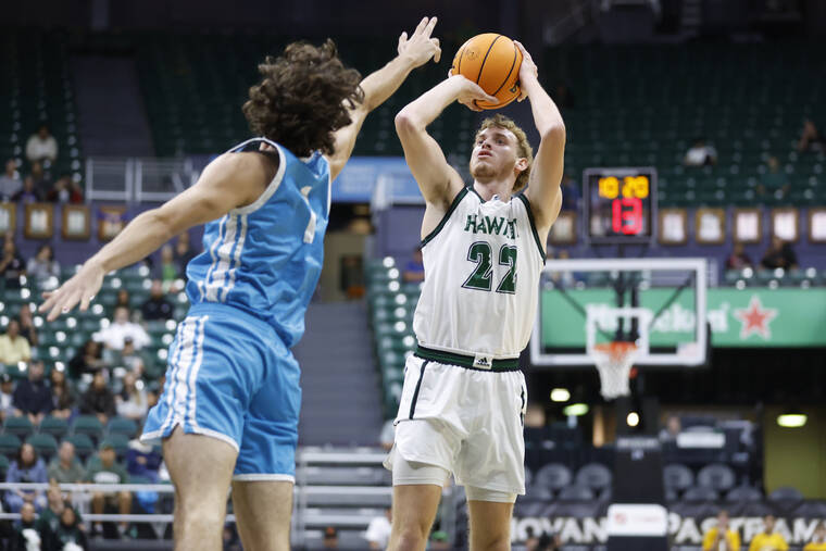 GEORGE F. LEE / GLEE@STARADVERTISER.COM
                                Hawaii Rainbow Warriors Ryan Rapp took a shot against Hawaii Pacific Sharks Pavle Kuzmanovic during an NCAA Men’s basketball game on Tuesday, Nov. 26, at the SimpliFi Arena, Stan Sheriff Center.