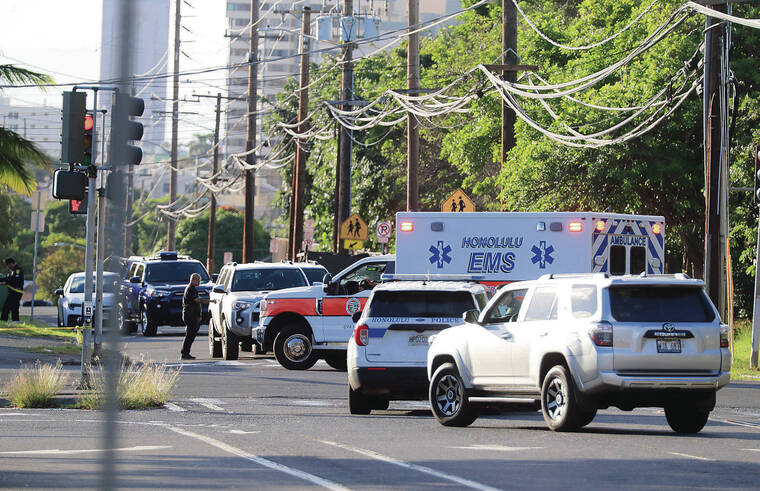 JAMM AQUINO / JAQUINO@STARADVERTISER.COM
                                An ambulance left the intersection of University Avenue and Dole Street on Jan. 1 after a daylong chase and shooting rampage that left police officers wounded and attempted murder suspect Sidney Tafokitau dead.