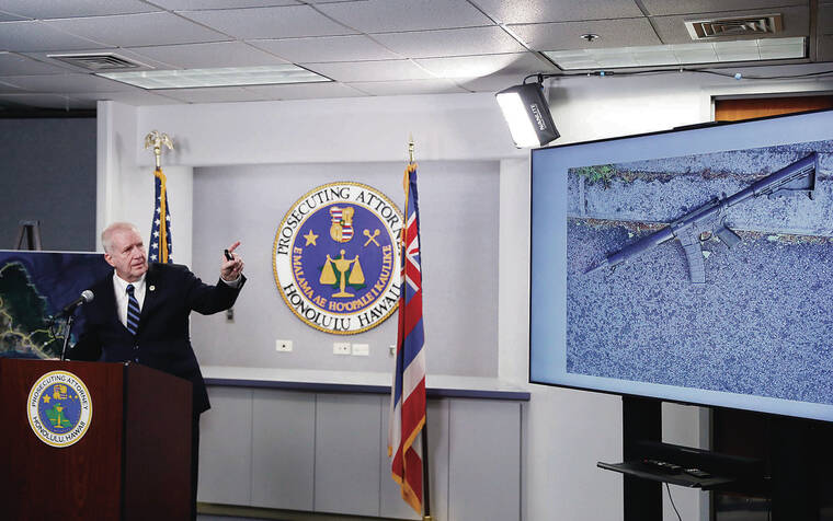 JAMM AQUINO / JAQUINO@STARADVERTISER.COM 
                                Prosecutor Steve Alm showed a photo of an AR-15 from the scene during a news conference Wednesday about the New Year’s Day shooting death of Sidney Tafokitau.