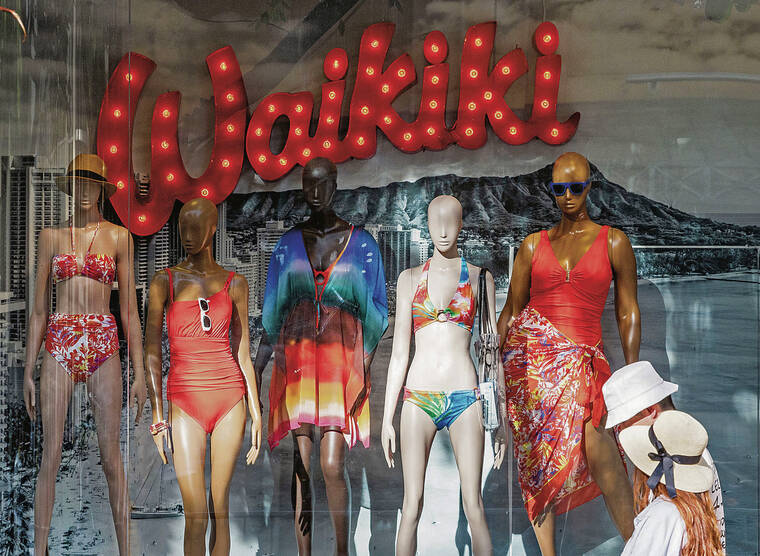 CINDY ELLEN RUSSELL / CRUSSELL@STARADVERTISER.COM
                                Above, a storefront window in Waikiki was decked out for tourists.