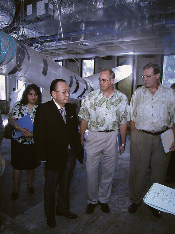 CRAIG T. KOJIMA / 2004 
                                U.S. Sen. Daniel Inouye looks over the damage with Neal Smatresk, UH Manoa vice chancellor, and David McClain, interim UH president, in the basement of Hamilton Library. The ceilings were lined with air ducts made of clear plastic.