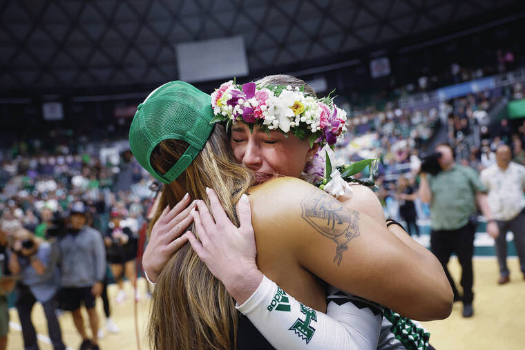 JAMM AQUINO / JAQUINO@STARADVERTISER.COM 
                                Hawaii senior Kate Lang embraced head coach Robyn Ah Mow during senior night festivities after the Rainbow Wahine defeated UC San Diego on Nov. 16.