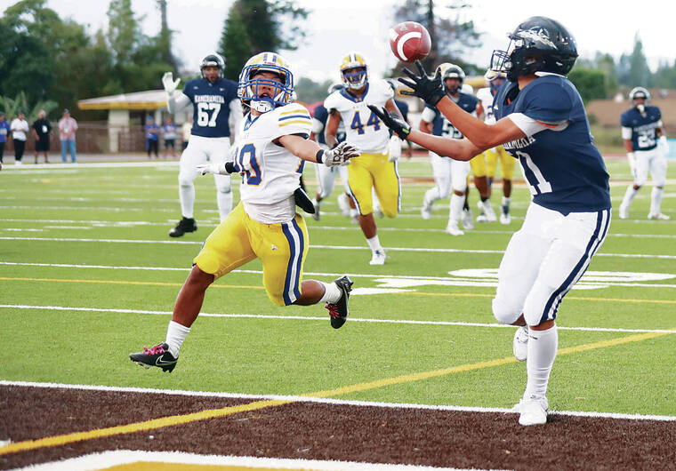 JAMM AQUINO /JAQUINO@STARADVERTISER.COM
                                Kamehameha-Maui wide receiver Tevyn Apo (11) makes a catch in the end zone ahead of Kaiser defensive back Kolt Glipa (20) for a touchdown during the first half of the 2024 HHSAA Division II football championship on Saturday in Mililani.