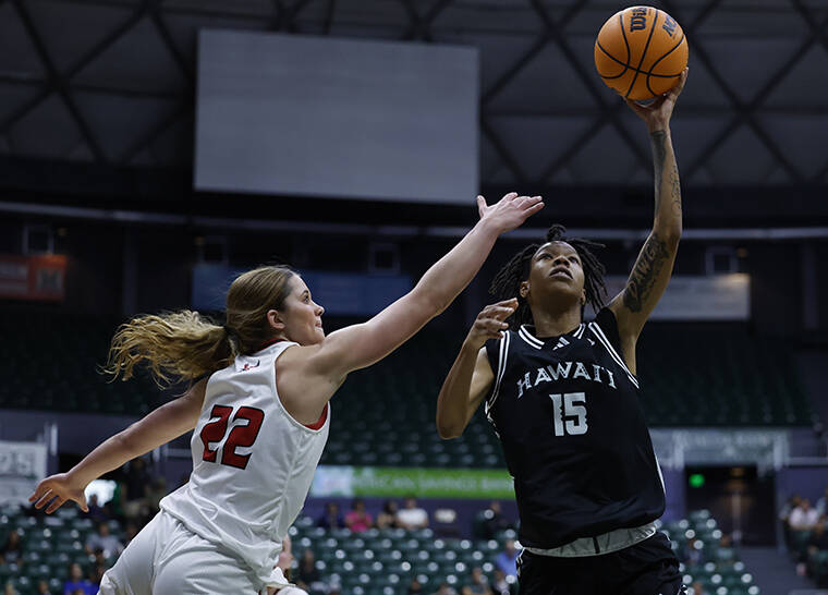 JAMM AQUINO/JAQUINO@STARADVERTISER.COM
                                Hawai’i guard Daejah Phillips (15) drives to the basket around Eastern Washington forward Kourtney Grossman (22) during the first half of a women’s NCAA basketball game on Sunday, Nov. 24, 2024, in Honolulu.