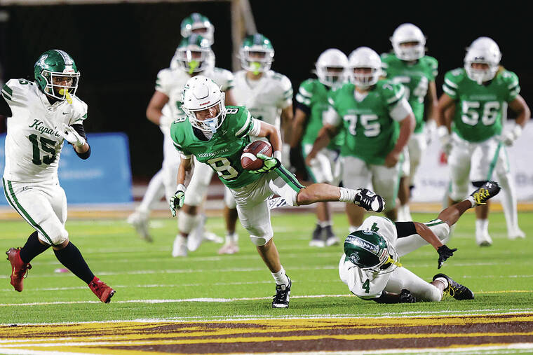 ANDREW LEE / SPECIAL TO THE STAR-ADVERTISER
                                Konawaena’s Aliimalu Tan (8) fends off Kapaa’s Takazee Thomas (4) after catching a pass during the HHSAA Division 1 Football Championship Game on Saturday,at Mililani High School.