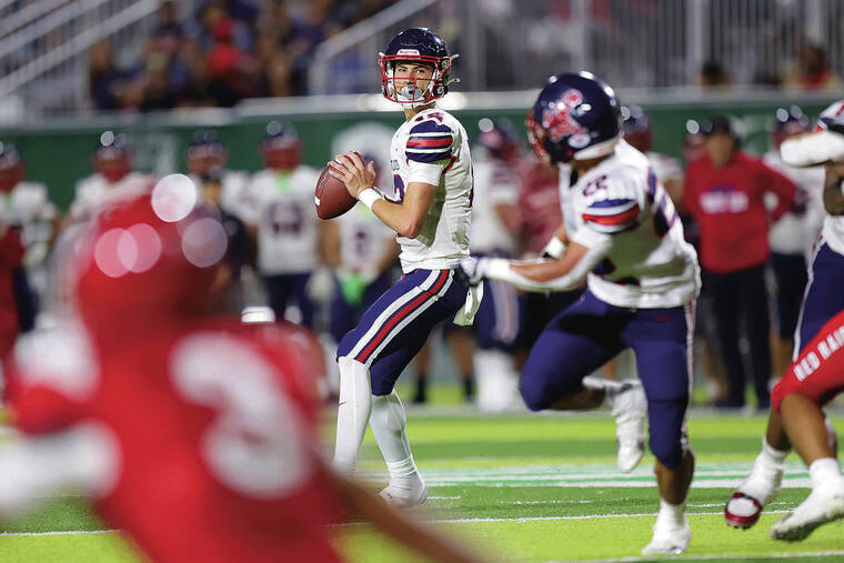 ANDREW LEE/ SPECIAL TO THE STAR-ADVERTISER
                                Saint Louis’ Nainoa Lopes (12) looks to pass during the HHSAA Open Division Football Championship Game against Kahuku on Friday at Clarence T.C. Ching Field in Honolulu.