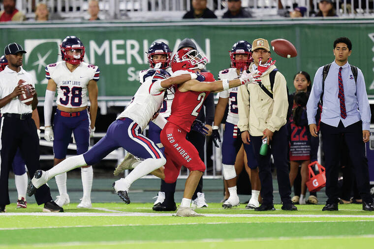 ANDREW LEE/ SPECIAL TO THE STAR-ADVERTISER
                                Saint Louis’ Braylon “Kalai” Lee (5) breaks up a pass intended for Kahuku’s Kaimana Carvalho (2) during the HHSAA Open Division Football Championship Game on Friday, at Clarence T.C. Ching Field in Honolulu.