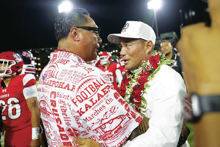 ANDREW LEE / SPECIAL TO THE STAR-ADVERTISER
                                Saint Louis’ head coach Tupu Alualu, left, greets Kahuku’s head coach Sterling Carvalho after the Crusaders won the HHSAA Open Division Football Championship Game, 17-10, Friday at Clarence T.C. Ching Field in Honolulu.