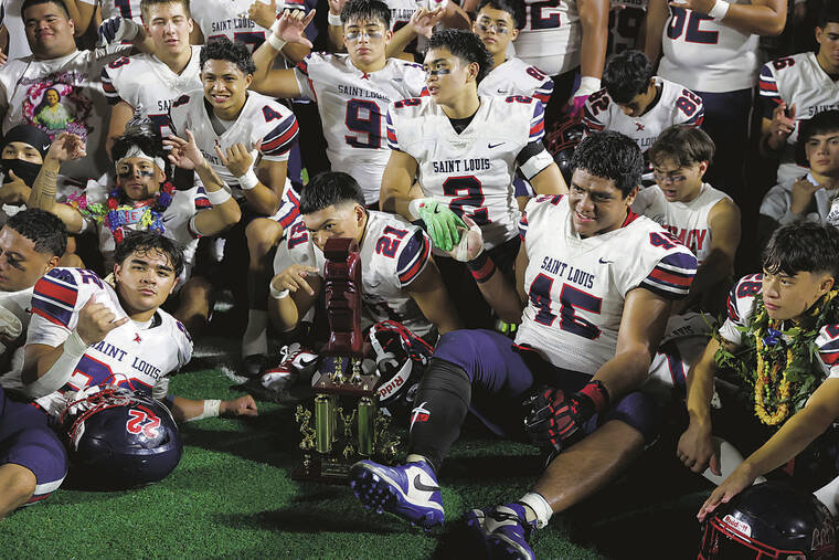 ANDREW LEE / SPECIAL TO THE STAR-ADVERTISER
                                Saint Louis’ Frank Abreu (2) and Pupualii Sepulona (45) celebrate after winning the HHSAA Open Division Football Championship Game 17-10 over Kahuku on Friday, at Clarence T.C. Ching Field in Honolulu.