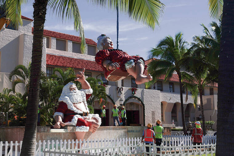 GEORGE F. LEE / GLEE@STARADVERTISER.COM
                                Personnel from the City Department of Facilities Management installed Shaka Santa and Tutu Male at Honolulu Hale on Tuesday. Their appearance marks the 40th anniversary at the Honolulu City Lights holiday display.